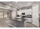 Open kitchen with granite counters, island, stainless appliances, modern cabinets, and lots of natural light at 16785 W Montana De Oro Dr, Surprise, AZ 85387