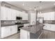Modern kitchen featuring white cabinetry, granite countertops, and stainless steel appliances at 16785 W Montana De Oro Dr, Surprise, AZ 85387