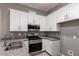 Kitchen showcasing white cabinets, gray granite countertops, stainless steel appliances at 16785 W Montana De Oro Dr, Surprise, AZ 85387