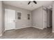 Living room featuring tile floors, gray walls, ceiling fan and white door at 16785 W Montana De Oro Dr, Surprise, AZ 85387