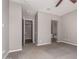 Main bedroom features neutral color palette and doorway to bathroom, large open area with carpet at 16785 W Montana De Oro Dr, Surprise, AZ 85387