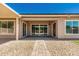 Covered patio with seamless indoor/outdoor flow through sliding glass doors, leading to a landscaped yard at 16785 W Montana De Oro Dr, Surprise, AZ 85387