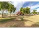 Community playground featuring play structures and mature shade trees for outdoor enjoyment at 16785 W Montana De Oro Dr, Surprise, AZ 85387