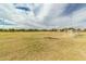Exterior shot of a well-manicured soccer field on a sunny day with lush green grass at 16785 W Montana De Oro Dr, Surprise, AZ 85387