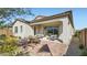Relaxing backyard with a covered patio, outdoor dining area, and lush landscaping at 16895 W Bronco Trl, Surprise, AZ 85387