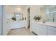 Bright bathroom featuring double sinks, white cabinets, and modern fixtures at 16895 W Bronco Trl, Surprise, AZ 85387