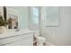 Well-lit half-bath with modern vanity and toilet at 16895 W Bronco Trl, Surprise, AZ 85387