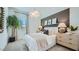 Stylishly decorated bedroom with unique decor and plenty of natural light at 16895 W Bronco Trl, Surprise, AZ 85387