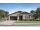 Charming single-story home features a two-car garage, desert landscaping, and a welcoming front porch at 16895 W Bronco Trl, Surprise, AZ 85387