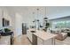Spacious open kitchen with a large island, stainless steel appliances, and a view of the dining and living areas at 16895 W Bronco Trl, Surprise, AZ 85387