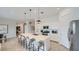 Contemporary kitchen features a large island, stainless steel appliances, and sleek white cabinetry at 16895 W Bronco Trl, Surprise, AZ 85387