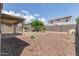 Backyard with desert landscaping, covered patio, and a swing set for Gathering fun at 19022 W Shangri La Rd, Surprise, AZ 85388