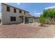 View of the backyard with desert landscaping, a covered patio, and a swing set at 19022 W Shangri La Rd, Surprise, AZ 85388