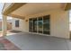 Covered patio with sliding glass doors leading to the interior of the home at 19022 W Shangri La Rd, Surprise, AZ 85388