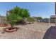 Fully landscaped backyard with desert landscaping and a swing set at 19022 W Shangri La Rd, Surprise, AZ 85388