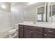 Neutral bathroom featuring a tub, shower, and a vanity with dark wood cabinets and a white countertop at 19022 W Shangri La Rd, Surprise, AZ 85388