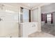 Bright bathroom featuring walk-in shower and a soaking tub, with a view into the bedroom at 19022 W Shangri La Rd, Surprise, AZ 85388