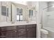 Bathroom showcasing a double sink vanity with dark wood cabinets and a shower/tub at 19022 W Shangri La Rd, Surprise, AZ 85388