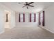 Bedroom features three windows, neutral carpet, views of the bathroom and lots of room at 19022 W Shangri La Rd, Surprise, AZ 85388