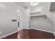Walk-in closet features hardwood floors, views of the bathroom, and shelves for storage at 19022 W Shangri La Rd, Surprise, AZ 85388
