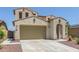 Beautiful two-story home boasting a spacious garage, beige stucco facade, desert landscaping, and a tile roof at 19022 W Shangri La Rd, Surprise, AZ 85388
