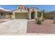 Charming two-story home showcasing a beige stucco facade, a spacious garage, and a well-maintained, desert-style landscaped yard at 19022 W Shangri La Rd, Surprise, AZ 85388
