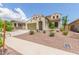 Delightful stucco home featuring desert landscaping, 2-car garage, a tile roof, and arched entryway at 19022 W Shangri La Rd, Surprise, AZ 85388