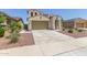 Attractive stucco home featuring a spacious driveway, a 2-car garage, desert landscaping, and a covered front entrance at 19022 W Shangri La Rd, Surprise, AZ 85388