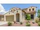 Attractive stucco home with desert landscaping, a two-car garage, and an arched covered entry at 19022 W Shangri La Rd, Surprise, AZ 85388