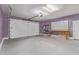 Spacious garage with a workbench, shelving, and ample storage space at 19022 W Shangri La Rd, Surprise, AZ 85388