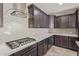 Updated kitchen with gas cooktop and range hood at 19022 W Shangri La Rd, Surprise, AZ 85388