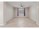 Neutral living room with ceiling fan and tile flooring at 19022 W Shangri La Rd, Surprise, AZ 85388