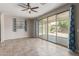 Bright living room with sliding glass doors and tile flooring at 19022 W Shangri La Rd, Surprise, AZ 85388