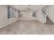 Spacious living room with tile floors, ceiling fan and staircase at 19022 W Shangri La Rd, Surprise, AZ 85388