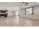 Open-concept living room flowing into kitchen, with sliding glass doors at 19022 W Shangri La Rd, Surprise, AZ 85388