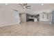 Bright open-concept living space showcasing tile flooring, a staircase, and a seamless transition to the modern kitchen at 19022 W Shangri La Rd, Surprise, AZ 85388