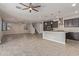 Open living area with kitchen island and staircase access at 19022 W Shangri La Rd, Surprise, AZ 85388