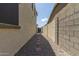 View of the home's side yard with a gated access to the backyard at 19022 W Shangri La Rd, Surprise, AZ 85388