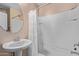 Bright bathroom featuring a pedestal sink, neutral walls, and a shower-tub combination at 2031 N 77Th Ln, Phoenix, AZ 85035