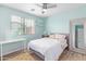 Stylish bedroom featuring modern decor, a ceiling fan, and natural light at 2031 N 77Th Ln, Phoenix, AZ 85035