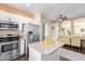Modern kitchen featuring stainless steel appliances, island with granite countertop, and open layout at 2031 N 77Th Ln, Phoenix, AZ 85035