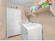 Functional laundry room with a washer, dryer, and ample storage space at 2031 N 77Th Ln, Phoenix, AZ 85035