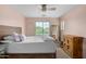 Cozy main bedroom with natural light and a ceiling fan at 2031 N 77Th Ln, Phoenix, AZ 85035