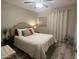Comfortable bedroom featuring a ceiling fan, wood floors and decorative pillows at 2110 E Williams Dr, Phoenix, AZ 85024