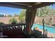 Inviting covered patio with outdoor seating area overlooks a sparkling pool and well-maintained backyard at 2110 E Williams Dr, Phoenix, AZ 85024