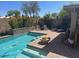 Inviting pool area features lounge chairs, surrounding landscaping, and a beautiful stone wall at 2110 E Williams Dr, Phoenix, AZ 85024