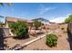 Backyard with a swing set, patio, and desert landscaping at 2177 W Agrarian Hills Dr, San Tan Valley, AZ 85144
