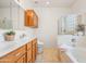 Bright bathroom featuring a double sink vanity, tile floors, and separate tub and shower at 2177 W Agrarian Hills Dr, San Tan Valley, AZ 85144