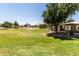 Expansive community park featuring green lawns, trees, playground, and shaded picnic areas at 2177 W Agrarian Hills Dr, San Tan Valley, AZ 85144