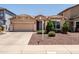Charming single-story home with a well-manicured front yard and a two-car garage on a bright sunny day at 2177 W Agrarian Hills Dr, San Tan Valley, AZ 85144